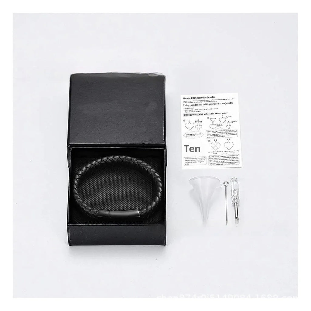 Black woven leather and stainless steel cinerary bracelet with engraving option on a gift box.