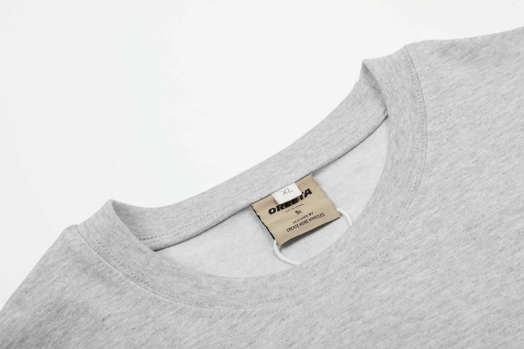Men's loose fit black and grey cotton long sleeve casual T-shirt on a hanger.
