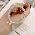 Close-up of a natural emerald jade bracelet with a handcrafted gourd design in Chinese style.