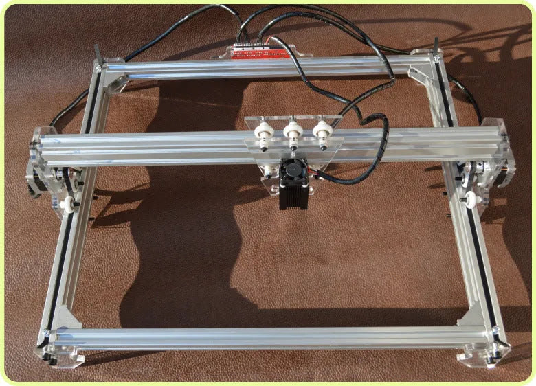 Miniature 3000mw laser engraving machine with a 400mm by 300mm base plate.