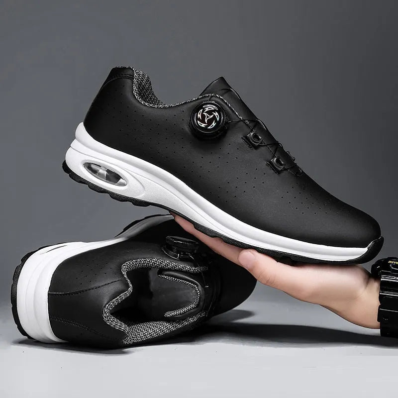 Black and white low top mesh casual shoes with cross shoulder straps and lace-up front.