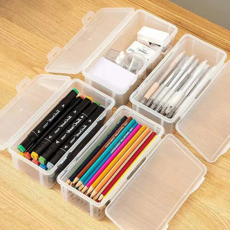 Clear plastic pencil storage box showing coloured pencils and drawing tools inside.