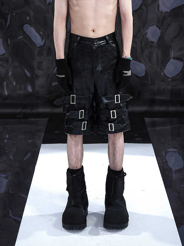 Men's black PU leather casual shorts with a distinctive ring design on the leg, shown in a cropped fit.