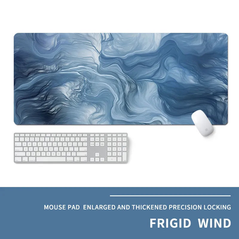 Oversized rectangular desk mat with printed cold-style graphic, placed under a keyboard and mouse.