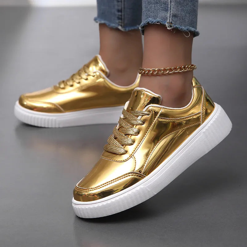 Gold sequinned unisex platform sneaker with thick sole and stitching detail on a white background.