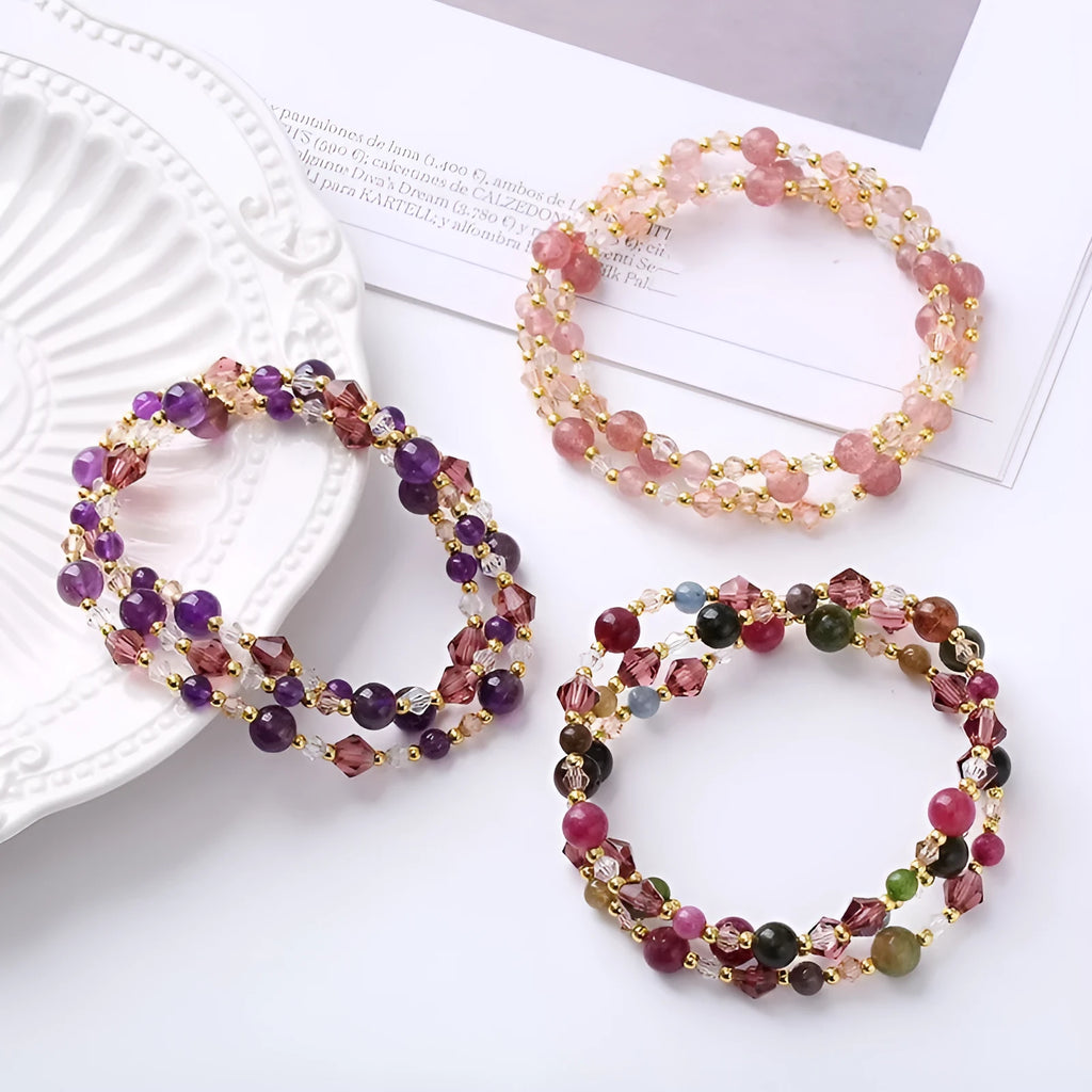 Women's adjustable three-ring bracelet with tourmaline, strawberry quartz, and amethyst crystal beads on elastic cord.