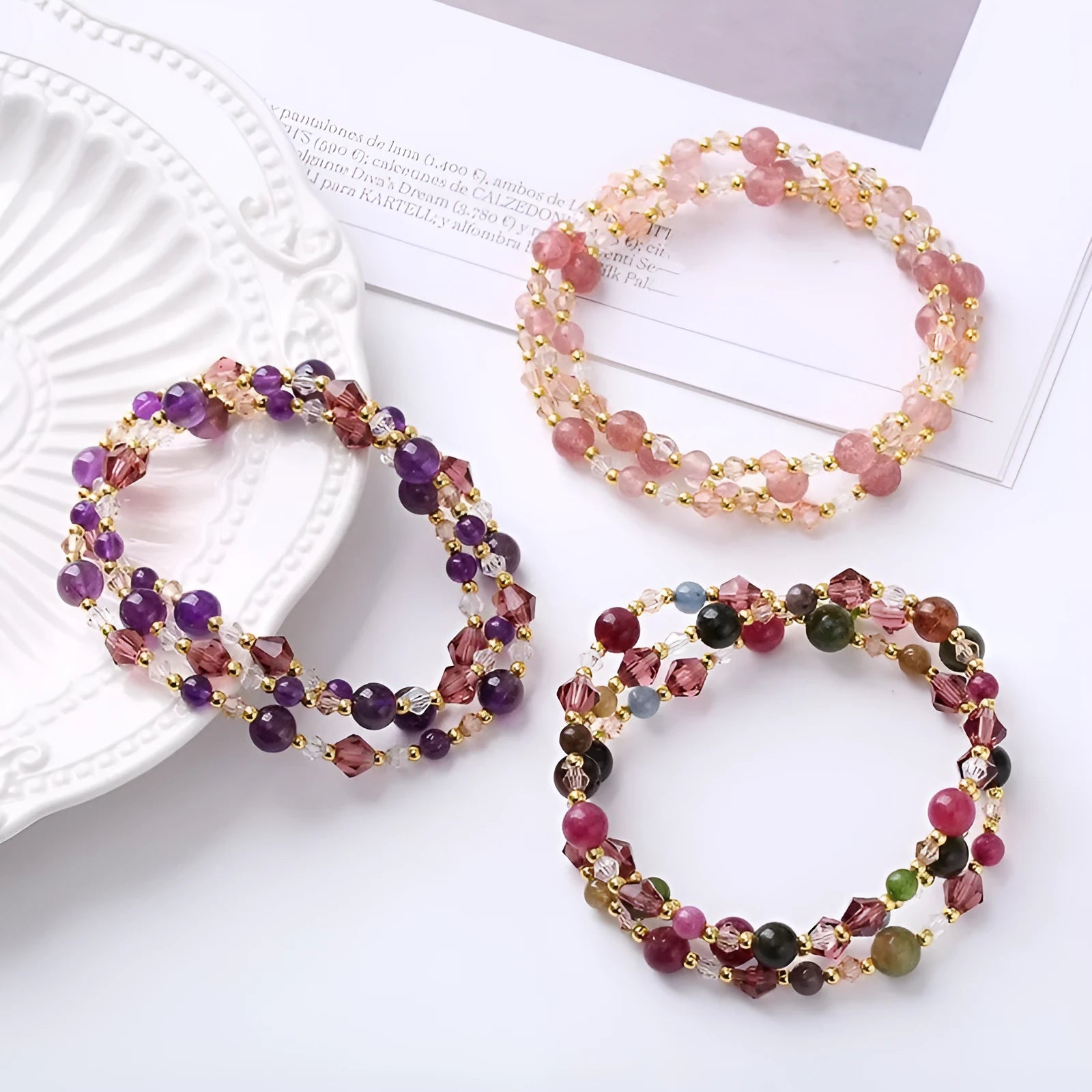 Women's adjustable three-ring bracelet with tourmaline, strawberry quartz, and amethyst crystal beads on elastic cord.