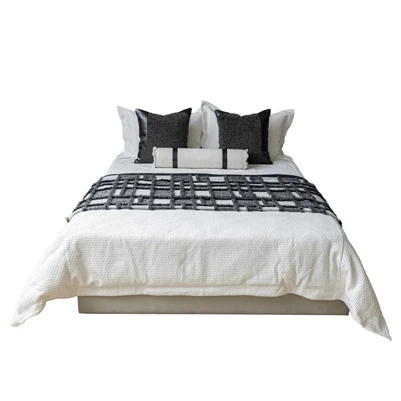 Modern minimalist grey and white plaid bed runner blanket set with leather round pillow on a 1.5m bed.