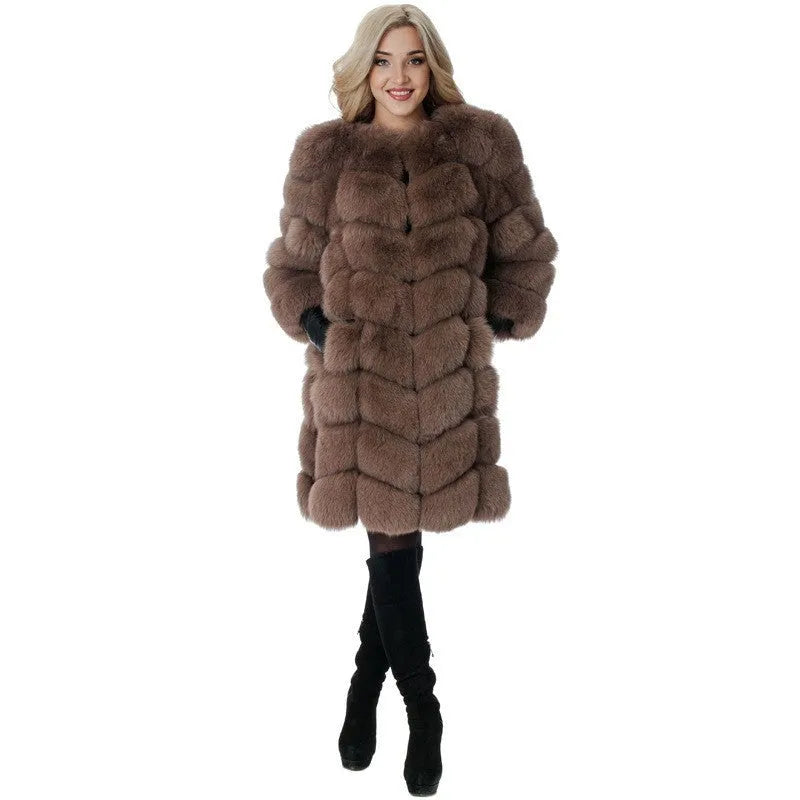 Women's thick black artificial fur coat with regular sleeves on a hanger.