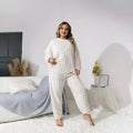 Women's creamy white plush crew neck two-piece lounge set with long sleeves and full-length trousers.