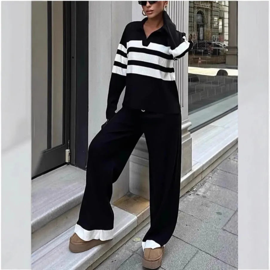 Women wearing black and white striped polo collar two-piece set with matching trousers