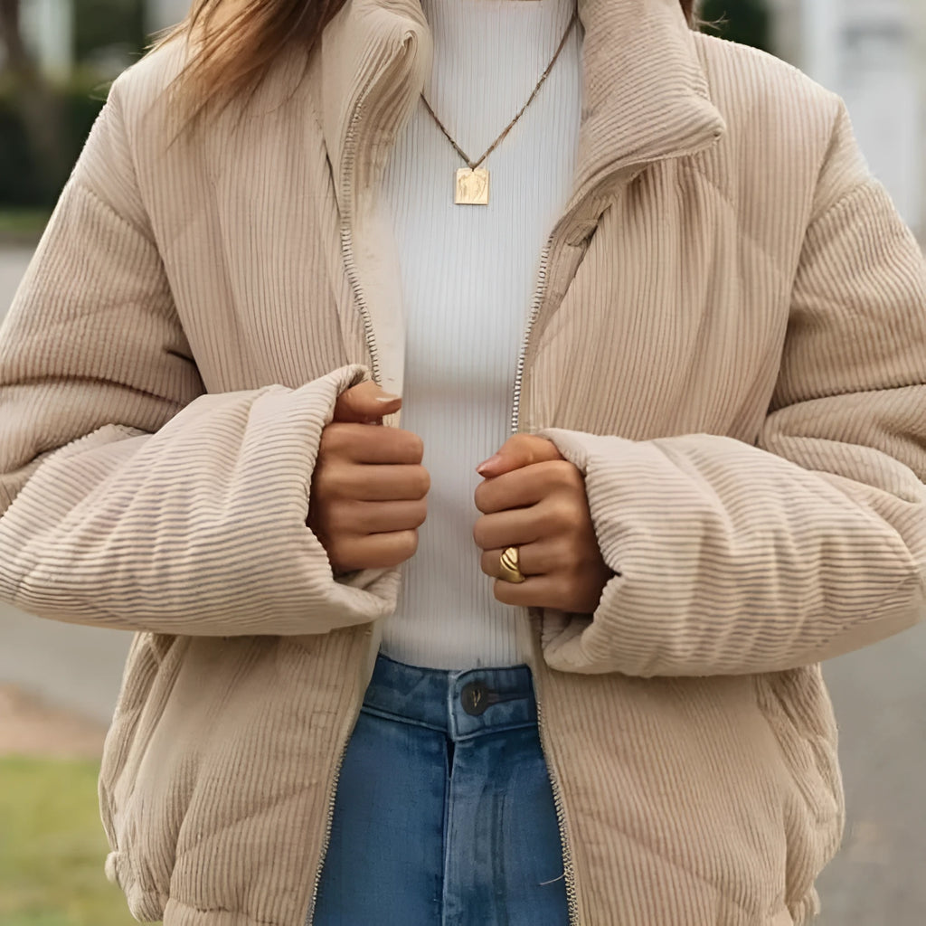 Apricot coloured women's corduroy jacket with stand collar, front zipper, and long sleeves.