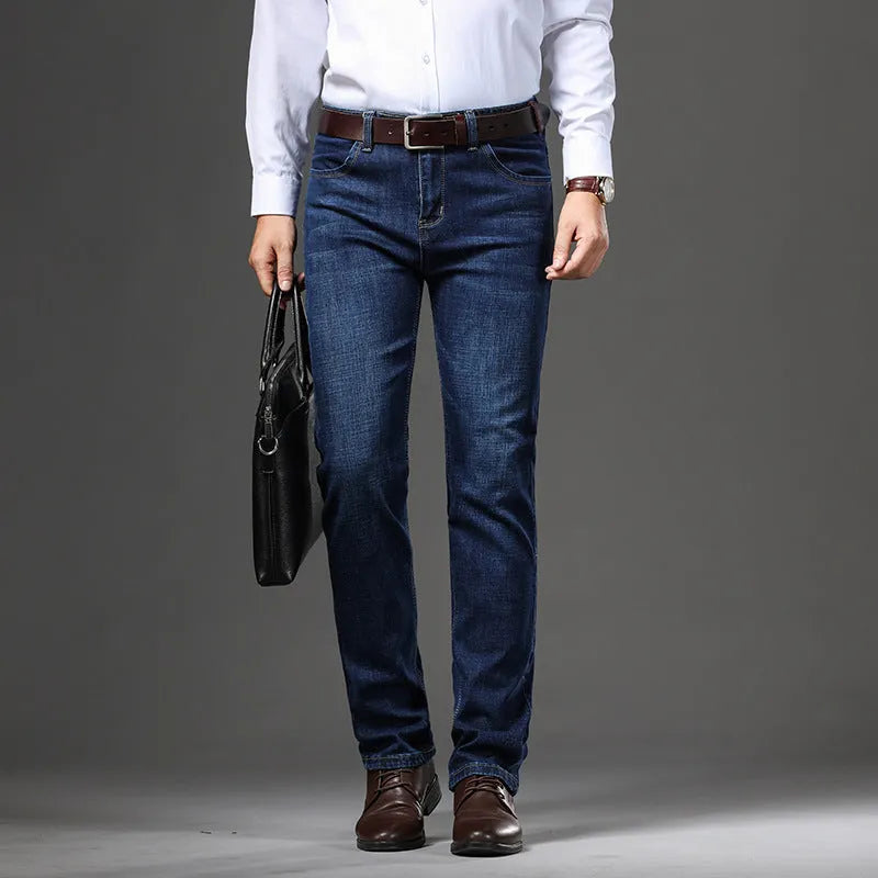 Men's black stretch denim jeans showing loose straight-leg fit with mid waist and zip fly detail