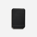 Black magnetic mobile phone holder case made from MOVAS leather and fibreboard, shown next to a phone.