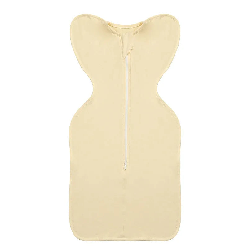 Newborn baby swaddled in bamboo fibre gauze sleeping bag with matching beanie in solid colour
