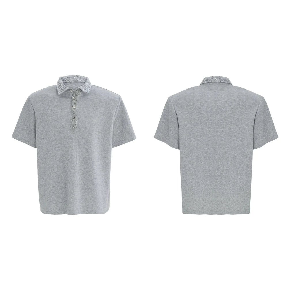Men's black loose-fit polo shirt with heavy embroidery and sequin detailing on the front.
