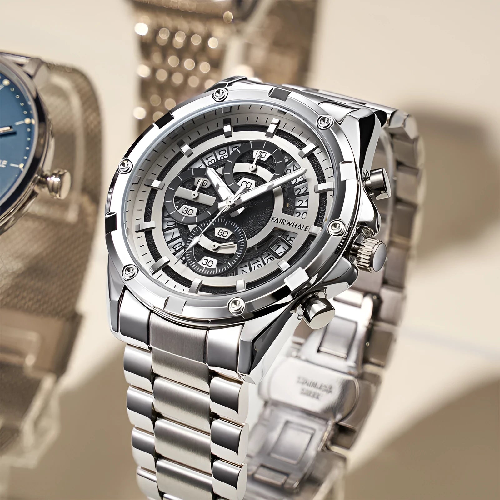 Men's stainless steel casual watch with luminous hands on wrist, showing blue dial and black case option.