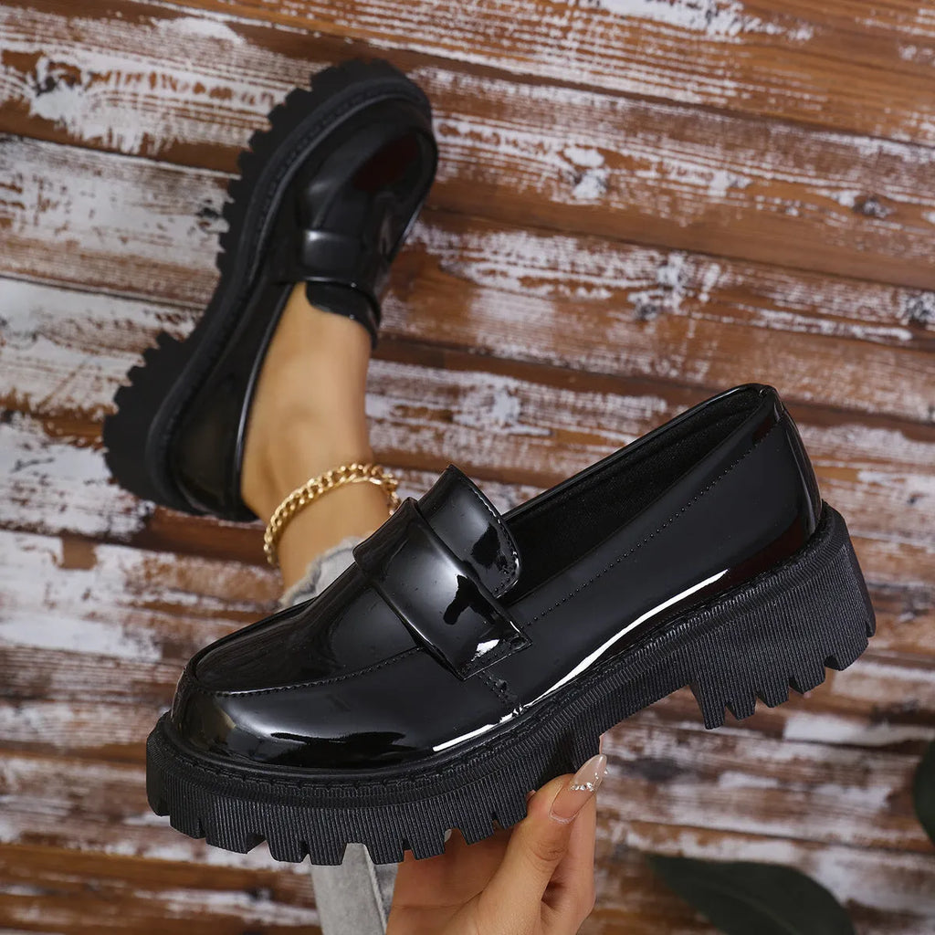 Plus size black chunky heel loafers with a thick rubber sole and slip-on design.