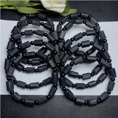 Natural black tourmaline rough stone bracelet with unpolished beads on wrist