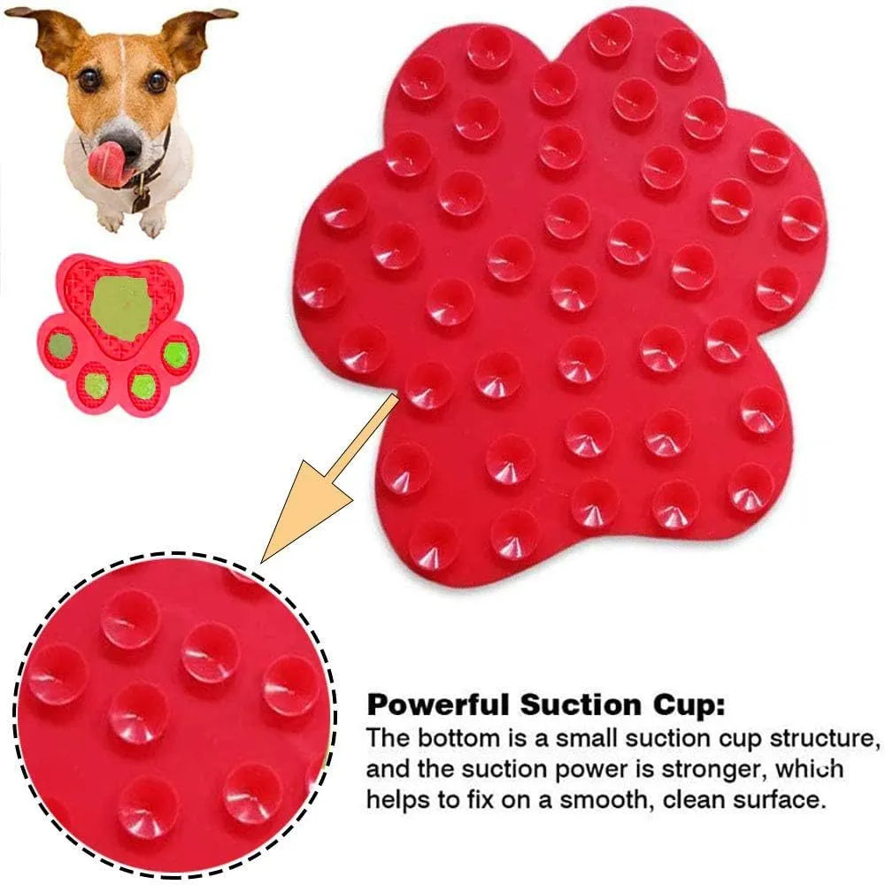 Blue bone-shaped silicone dog licking mat with suction cups on back, held against a tile wall.