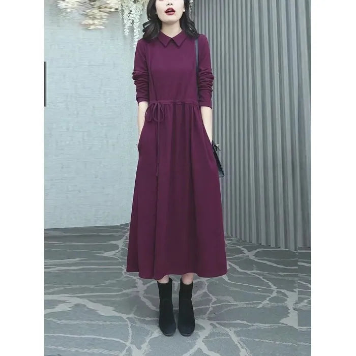 A purplish red plus size long sleeve dress for women, featuring a long skirt and urban commute style.