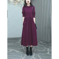 A purplish red plus size long sleeve dress for women, featuring a long skirt and urban commute style.