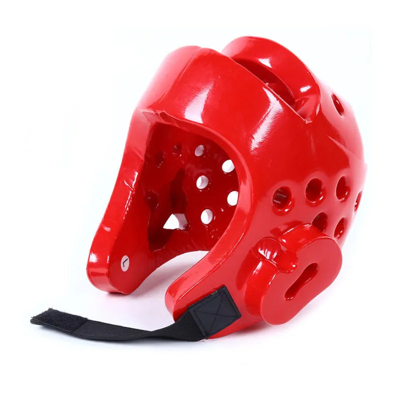 Red karate taekwondo protective gear set with leg guard, helmet and boxing gloves on white background