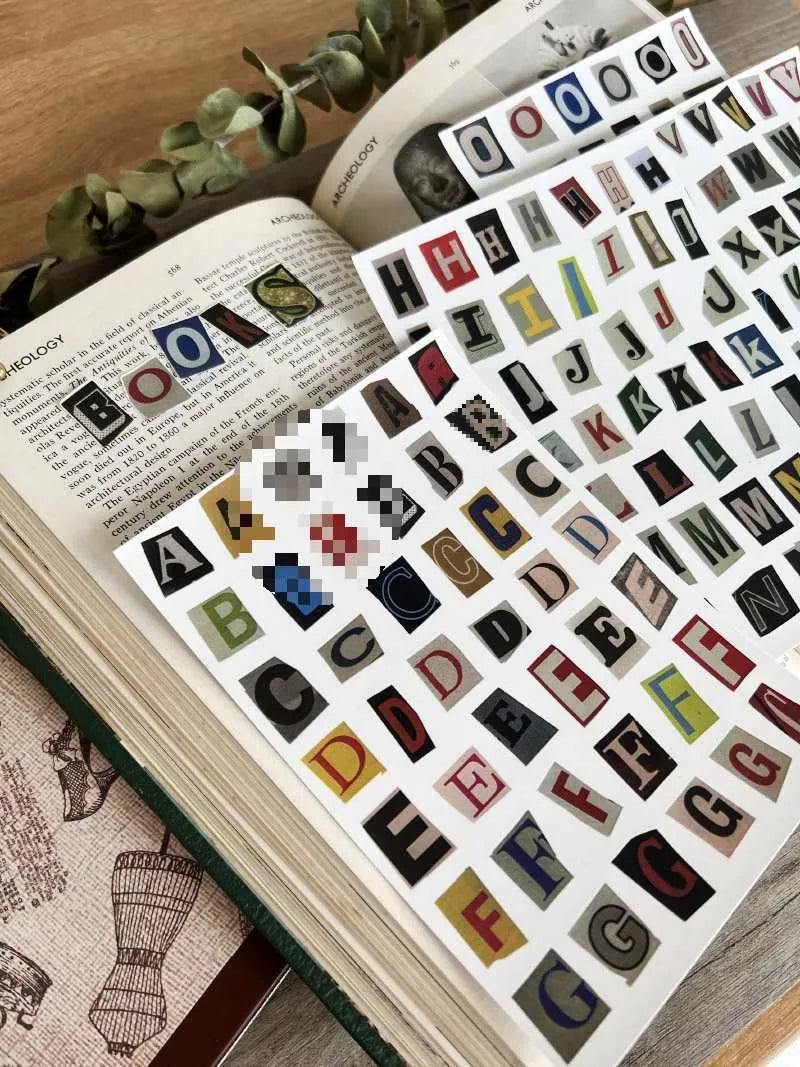 English alphabet and number sticker sheets showing colourful letter sets with cute designs for crafts and labelling