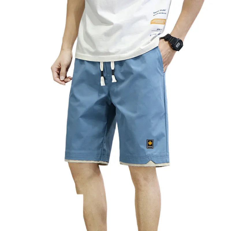 Men's loose-fitting Korean-style casual shorts in khaki, shown on a model.