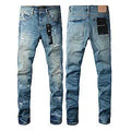 Black slim fit skinny jeans on a man, showing straight leg cut and manual distressing details.