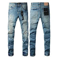 Black slim fit skinny jeans on a man, showing straight leg cut and manual distressing details.