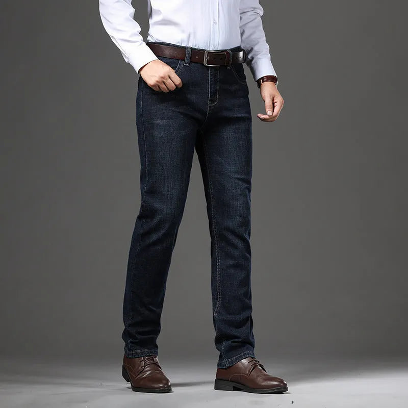 Men's black stretch denim jeans showing loose straight-leg fit with mid waist and zip fly detail