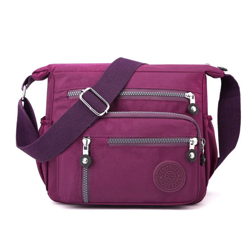 Soft nylon messenger bag in square vertical shape with an adjustable shoulder strap.