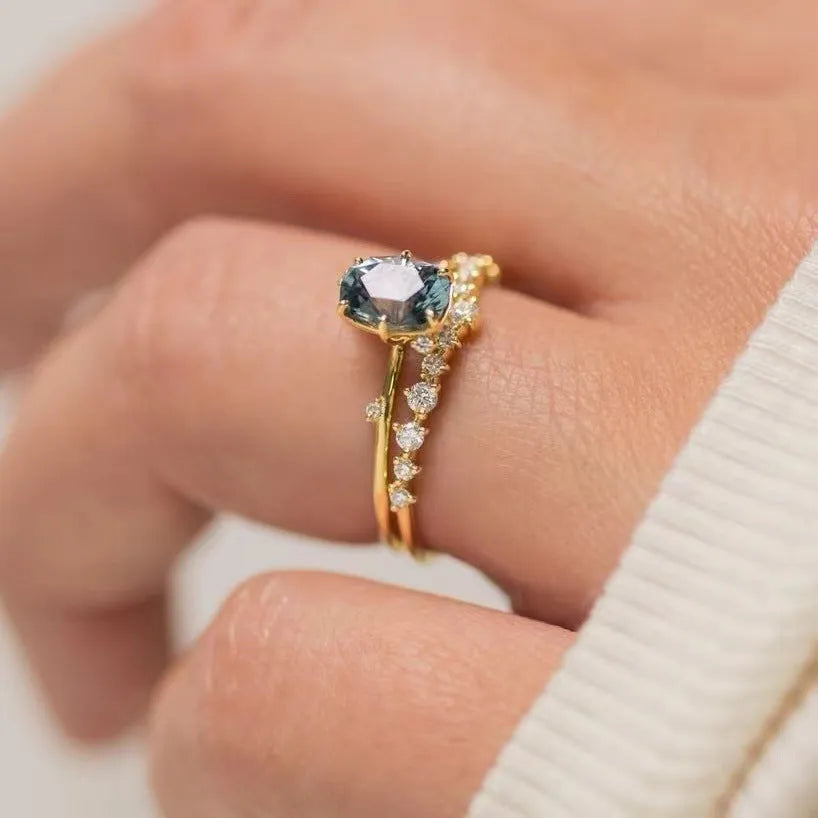 Gold-plated floral ring with green zircon stone, shown on female hand