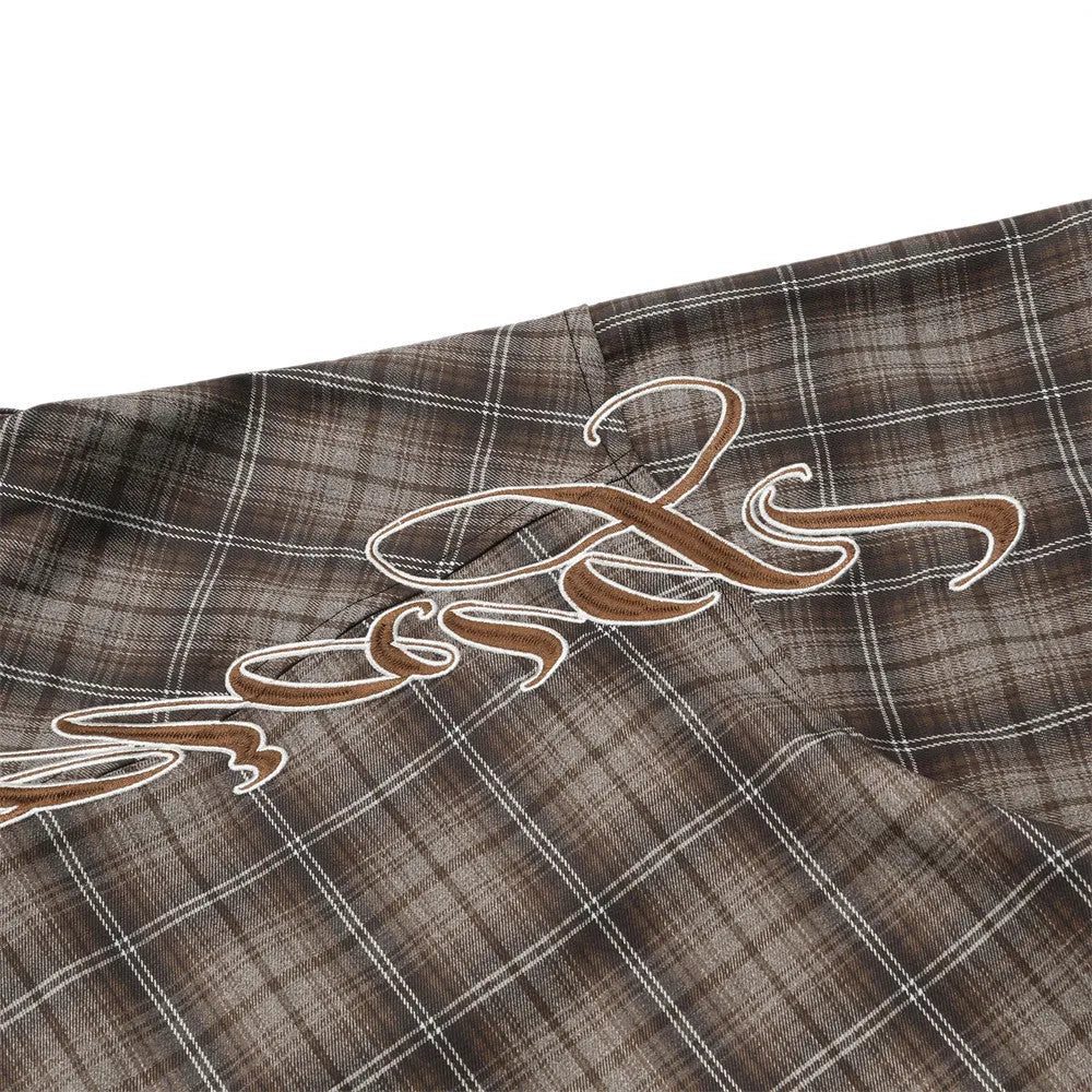 Men's black and brown plaid short sleeve shirt with embroidered lettering and lapel collar.