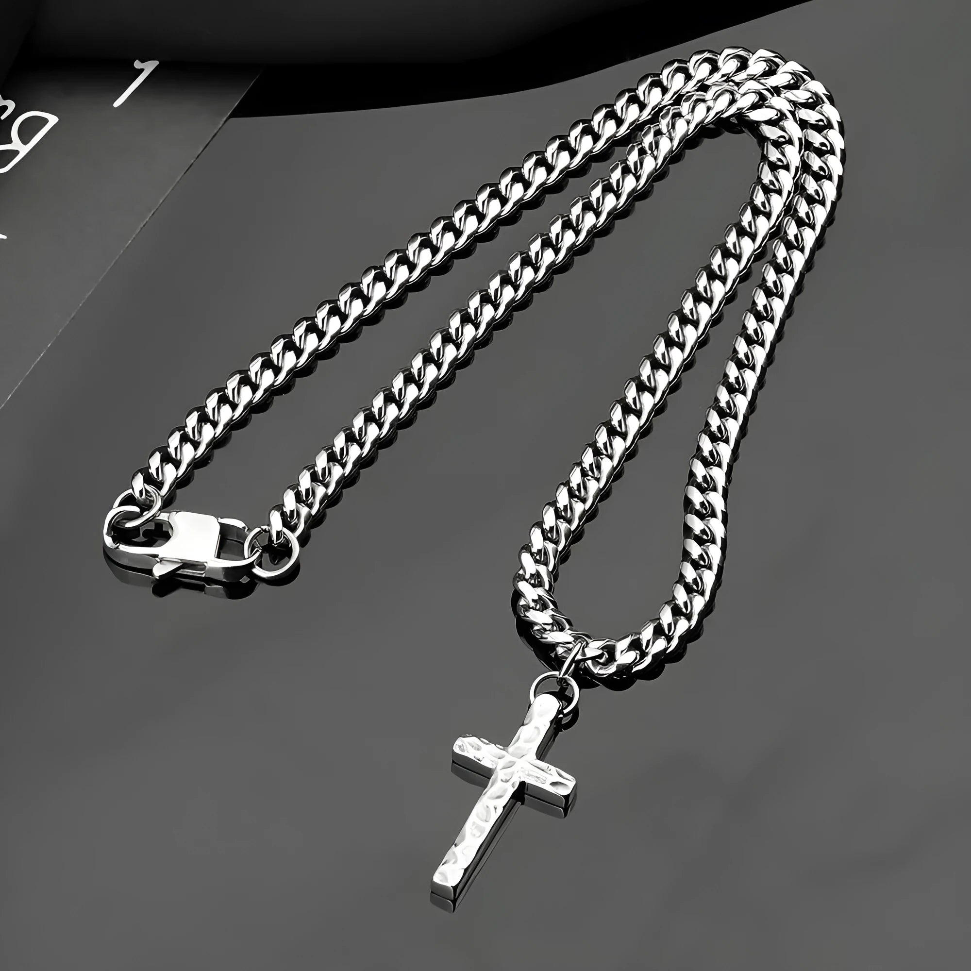 Titanium steel Cuban chain necklace in steel colour with geometric links on neutral background