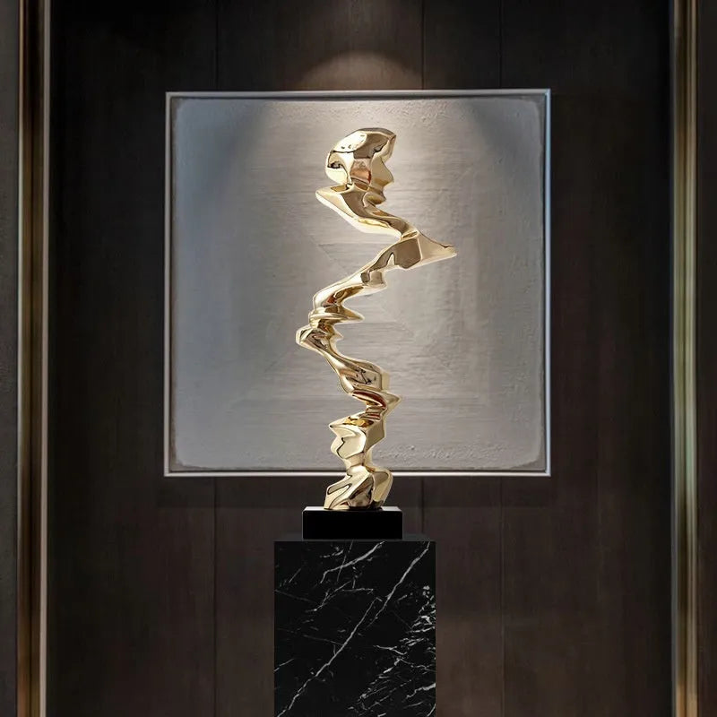 Modern abstract still life sculpture ornament in natural resin on a wooden table.