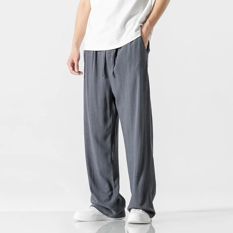 Men's beige bamboo fibre linen trousers with a straight leg, cropped length, and drawstring waist on a mid-rise.
