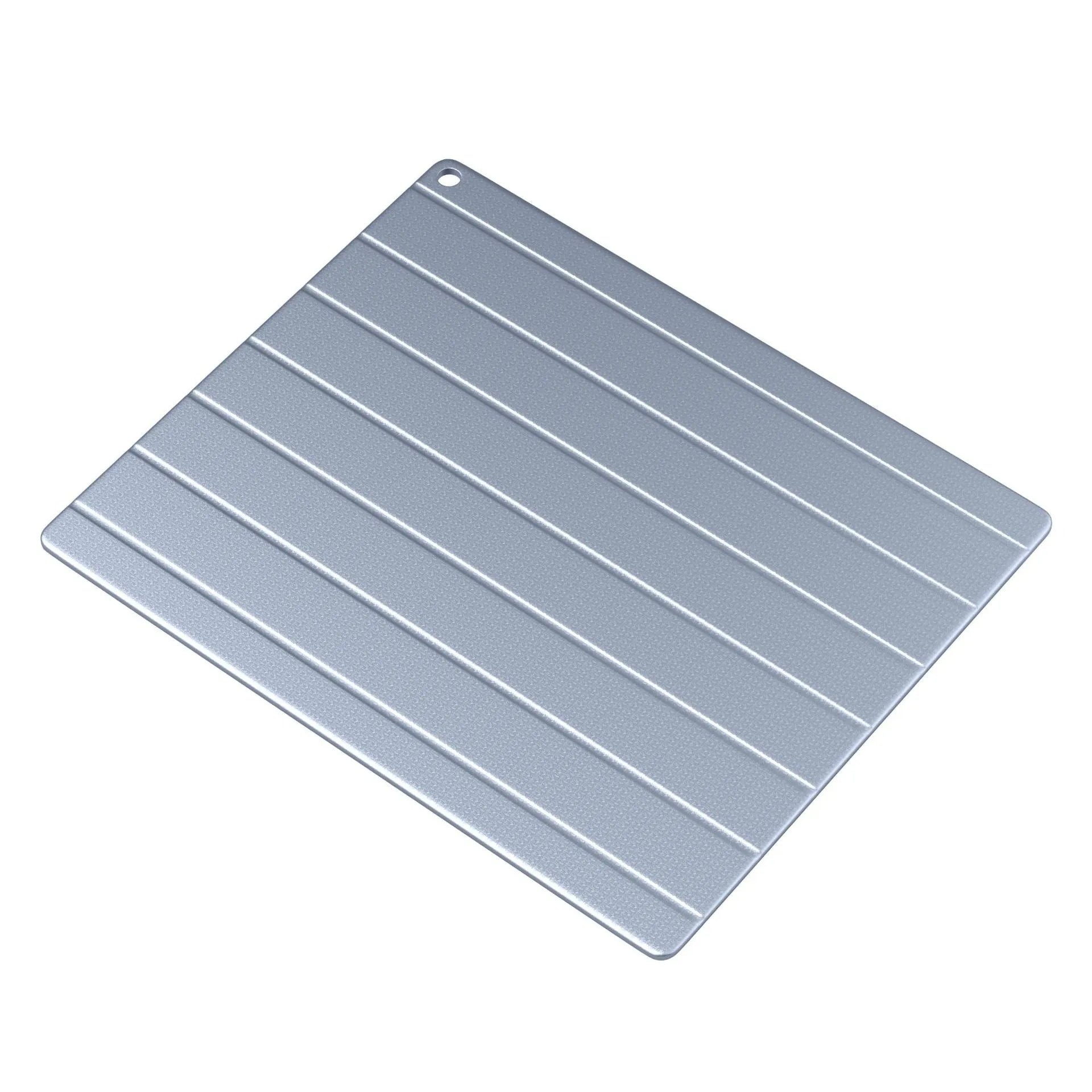 Aluminium household defrosting plate for food on a kitchen countertop.