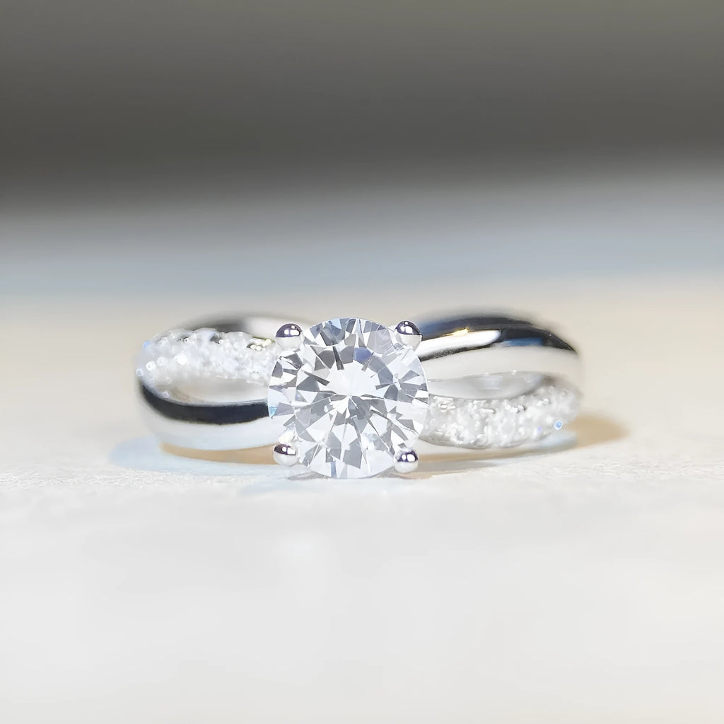 Geometric silver moissanite ring with twisted band and 1 karat centre stone in four-claw setting