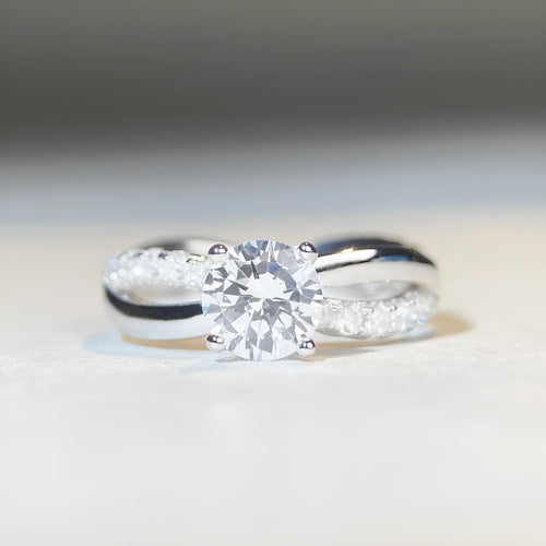 Geometric silver moissanite ring with twisted band and 1 karat centre stone in four-claw setting