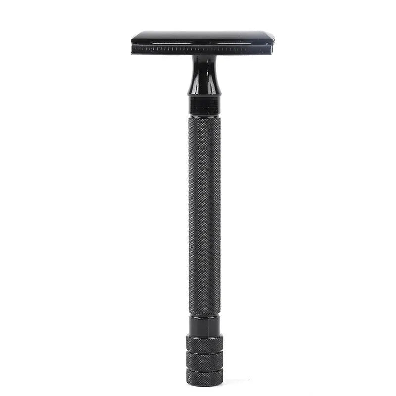 Traditional manual shaving razor and brush set in silver and black finish on a wooden surface.