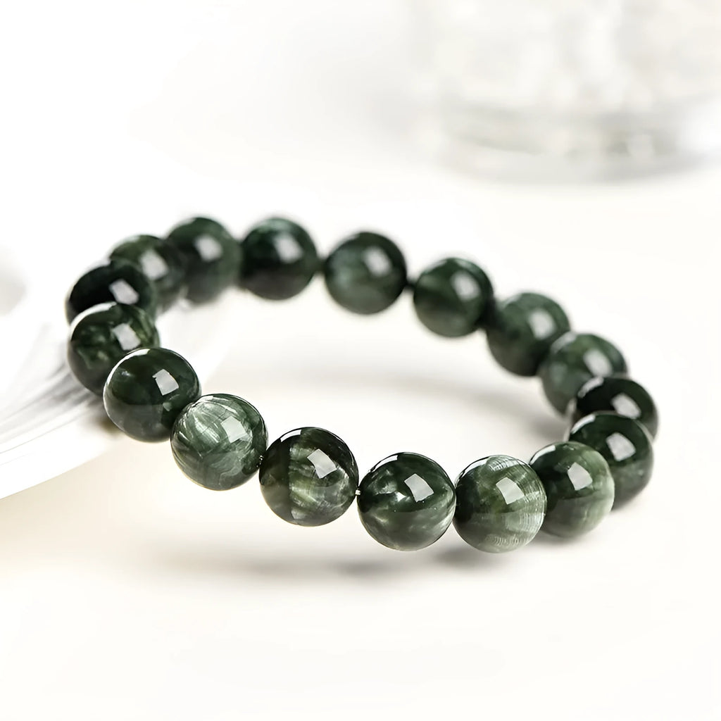 Green Dragon Crystal bracelet with Ruyi design and 8-9mm round beads on a wrist.