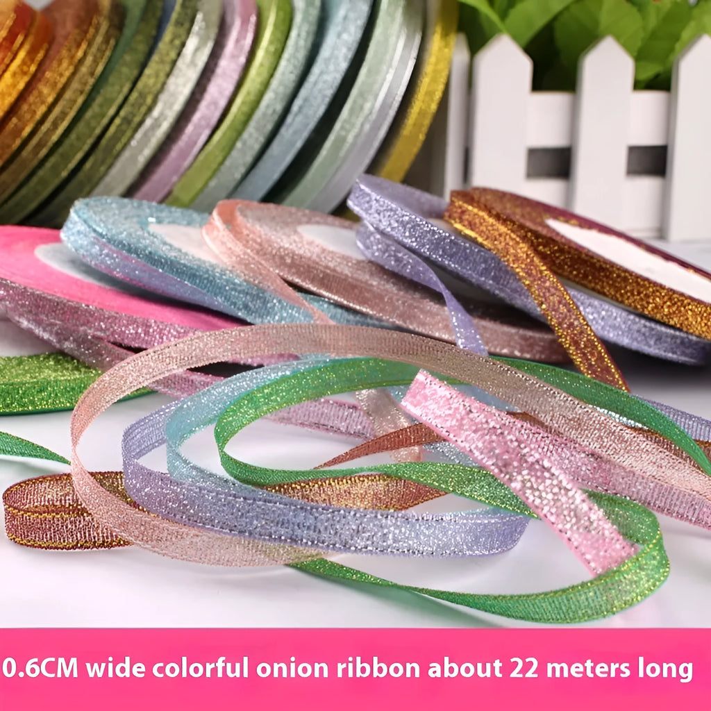 Roll of narrow gold polyester ribbon next to a wrapped gift box.