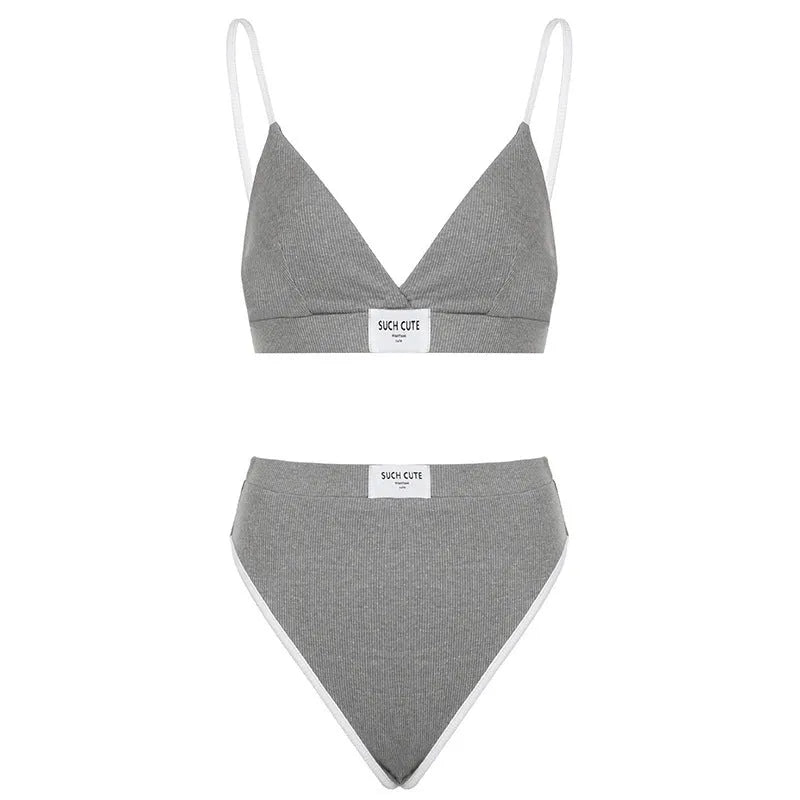 Grey women's bikini set with embroidery and contrast colour binding on a sleeveless top and shorts.