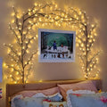 Flexible DIY willow vine LED light garland with warm white lights bent into a decorative shape.