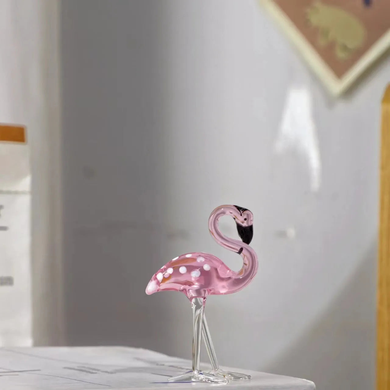 Pink crystal flamingo decorative ornament on table with modern minimalist style