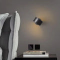 Modern minimalist wall lamp with a copper finish in black or gold colour options.