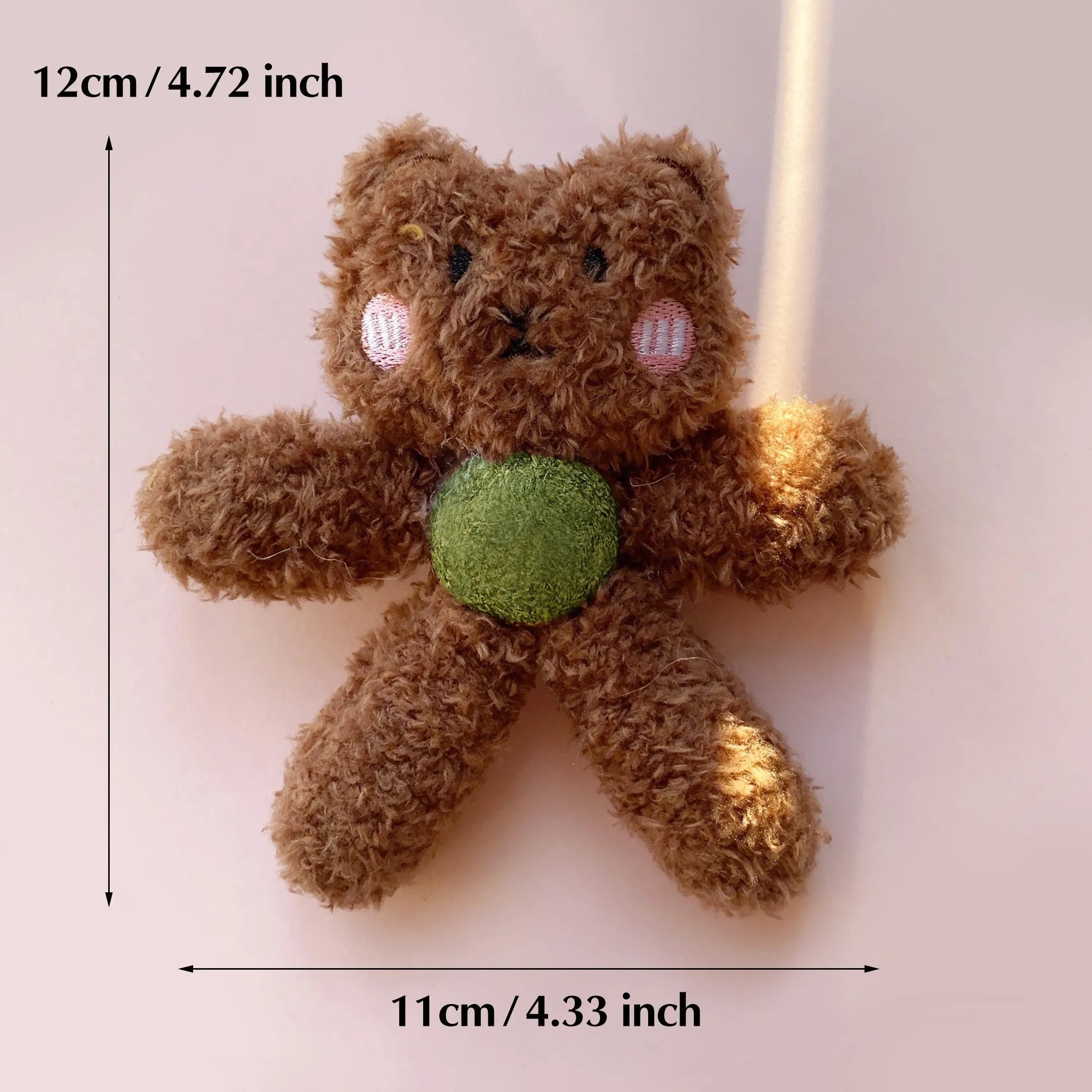 Soft brown bear-shaped catnip chewing ball toy for cats on a white background.