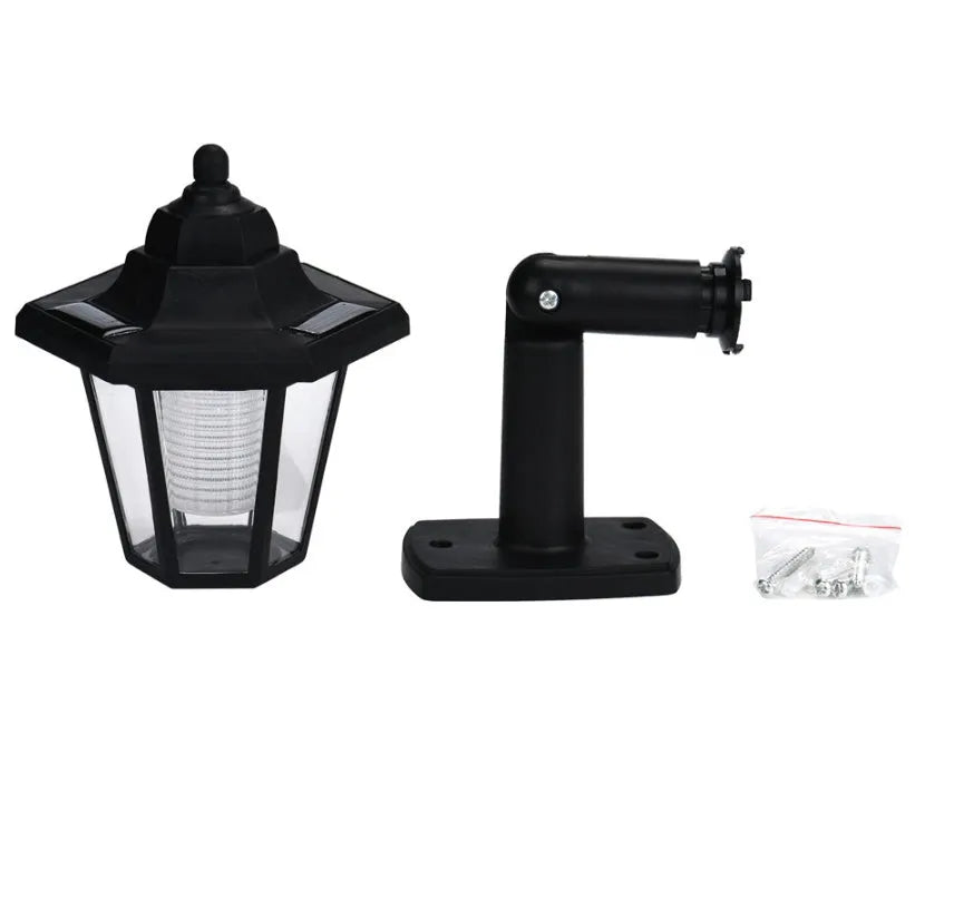 Black hexagonal solar wall light for outdoor mounting with automatic light sensor